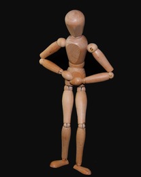 Wooden figure holding stomach