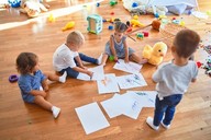 Group of children drawing and playing
