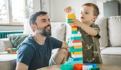Parent and child building a tower 