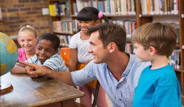 Man teaching a group of younger children. 