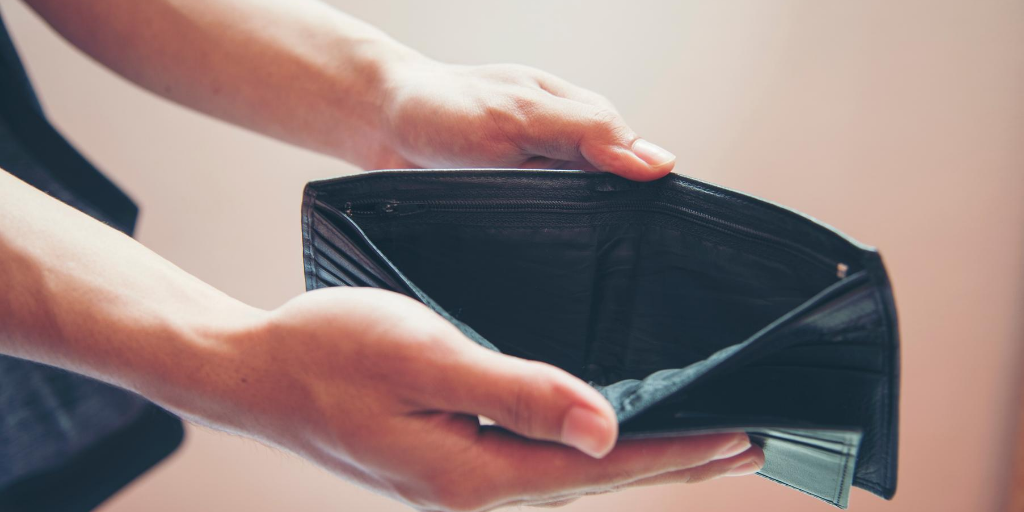 Man holding open an empty wallet