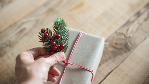 Parcel wrapped in brown paper with decorative string and decoration
