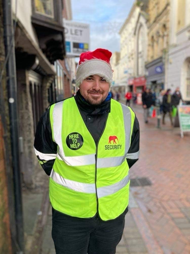 Man in high visibility jacket with Santa hat on