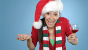 woman wearing santa hat holding a glass of wine