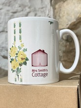 Mrs Smith's Cottage branded mug, white background with a red logo