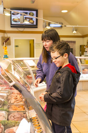 People shopping at a butchers