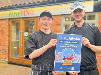 Chefs at Panevino holding a Free Parking poster