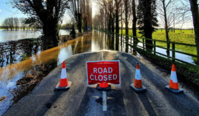 Road closed sign on flooded road