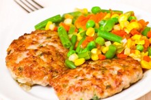 turkey and sweetcorn burgers with mixed vegetables on a plate