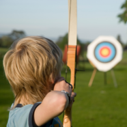 Young boy playing archery