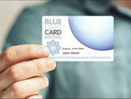 A person holding their Blue  Light Card towards the camera