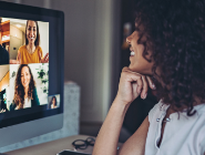 A woman in an online meeting smiling