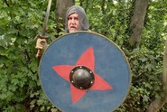 A picture of a man dressed in chain mail, holding a spear and shield.