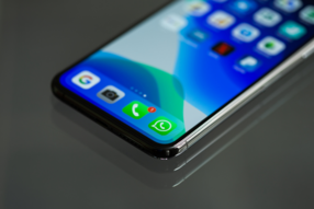 Smart phone showing different apps on the home screen, including WhatsApp