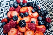 Close up of a bowl of raspberries, strawberries, blackberries and blueberries