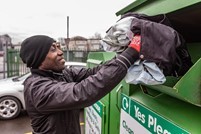 Man putting recycling in a recycling bin