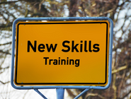 Road sign with text 'new skills training'