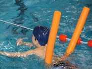 Child swimming with a pool float