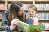 Child and carer reading together