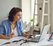 A woman sat at her desk, using a computer