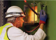 Man looking  in a furnace at an Energy Recovery Facility