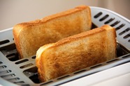 Two slices of toast in a toaster