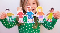 Child with paper cut out dolls