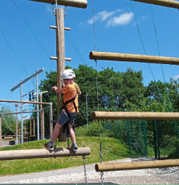 Child on a high ropes activity on a short break