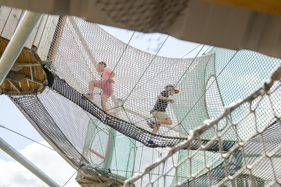 Children running through the high nets at Adventures