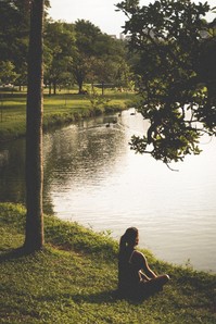 Woman peers out over lake