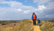 Person and child on a sand dune at Kenfig National Nature Reserve
