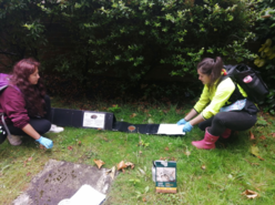 Students from Cardiff University bait a hedgehog tunnel with food to monitor hedgehog numbers