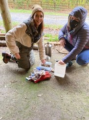 Teachers practice lighting a kelly kettle to boil hot water