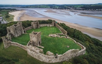 aerial photo of a castle by the coast
