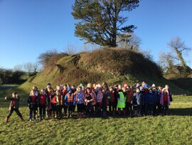 Pupils from Ysgol Trellech stand near a local landmark