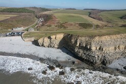 Dunraven beach - aerial image showing the shoreline, cliffs and carpark behind