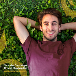 close up of man lying on grass wearing a t shirt WCP