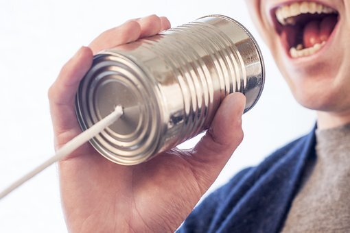 Someone talking on a tin can phone