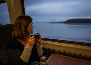woman looking out of a train window