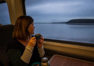 woman looking out of a train window