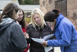 Teachers look at an activity plan for outdoor learning