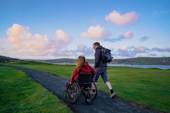 wheelchair user on coast path