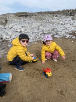 Two children play on a beach