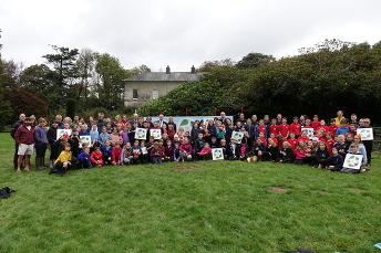 Children receive outdoor learning award - gathered in grass with dignataries