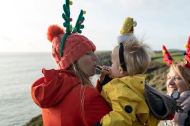 People wearing Christmas decorative headgear on the Wales Coast Path