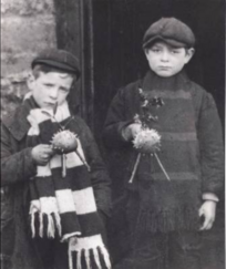 Two boys collecting calennig pictured in a doorway 