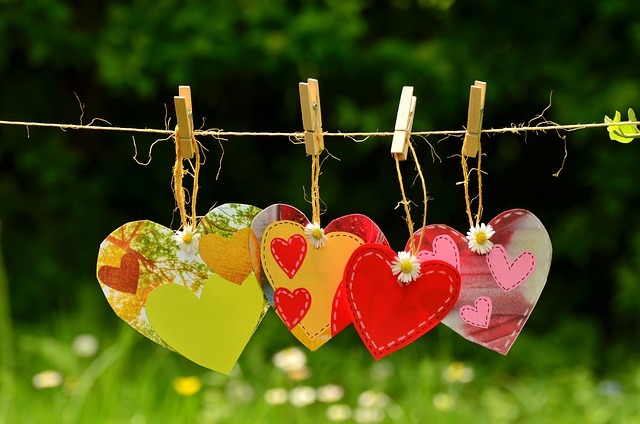 Paper love hearts hung on a clothes line with pegs