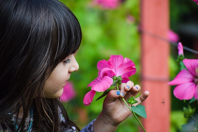 A child smells a flower