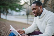 Man reads a book outside