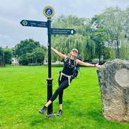 Woman celebrating the end of long hike on the Wales Coast Path